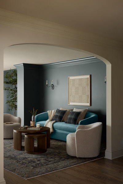Living room vignette featuring Cosgrove Sofa, Bailey swivel chair and Sewell Nesting Table.